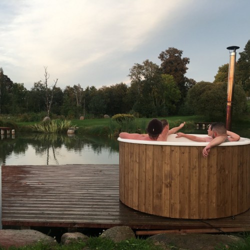 Outdoor fiberglass hot tub with wood trim